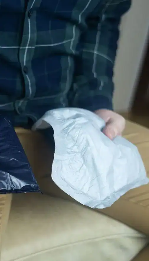 Image of man holding incontinence pads as part of overactive bladder treatment Manchester