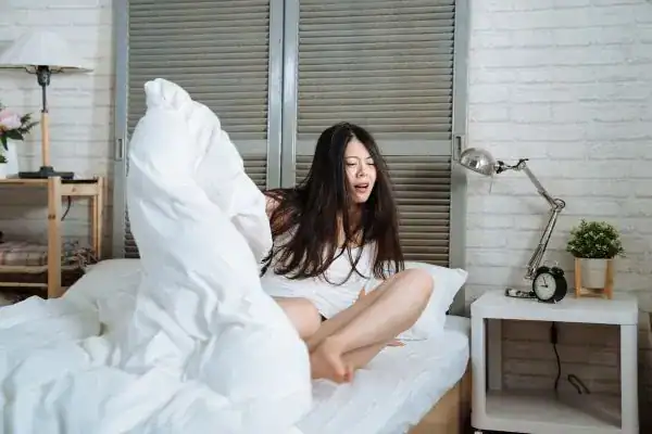 Image of woman getting up because of nighttime leaks Manchester